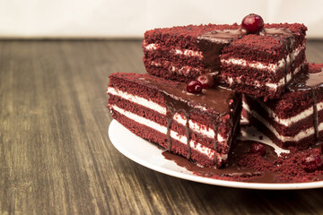 Cake with cranberries and cream on a wooden background.
