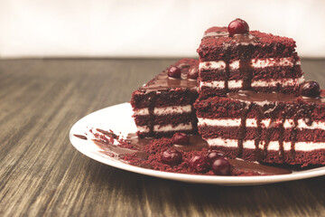 Cake with cranberries and cream on a wooden background.
