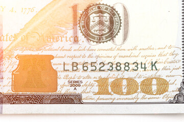 Fragment of the Obverse side of 100 one hundred dollars bill banknote with sunlight. 100. New sample money.