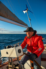 Obraz premium Man steering yacht on the bay of Alicante, Costa Blanca, Spain