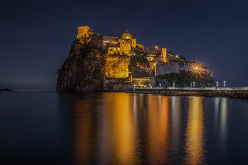 Fototapeta na wymiar Night view of Aragonese Castle (Castello Aragonese), the most famous landmark of Ischia, Campania region, Italy
