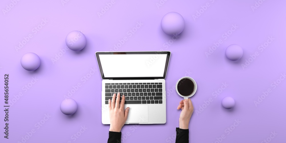 Poster person using a laptop computer with abstract spheres from above