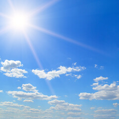Naklejka na ściany i meble Blue sky, sun and beautiful clouds.