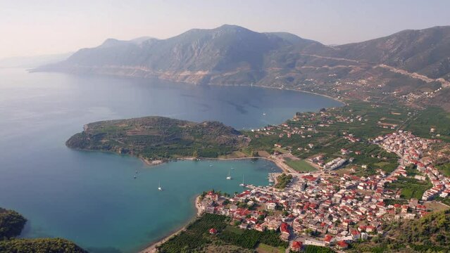 4k drone flight back footage (Ultra High Definition) of Palaia Epidavros, small town in the Argolis prefecture of Peloponnese, Greece. Spectacular summer seascape of Mediterranean sea.