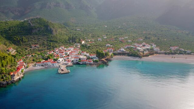 4k drone forward video (Ultra High Definition) of Paralia resort. Colorful outdoor scene of Peloponnese peninsula, Greece, Europe. Sunset on Mediterranean seascape.