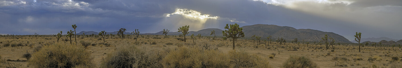 Naklejka premium Image of a spectacular weather scene with impressive sun rays through a hole in the clouds