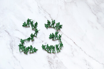 23 number date made of plastic toys soldiers on abstract marble background. February 23 Holiday,...