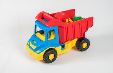 Truck. Plastic toy multicolored cars isolated on white background.