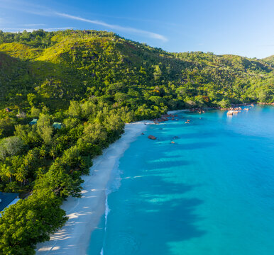 Panoramic aerial view of Anse Lazio facing Chevalier Bay, a turquoise shoreline with paradise beach, Grand Anse, Seychelles.