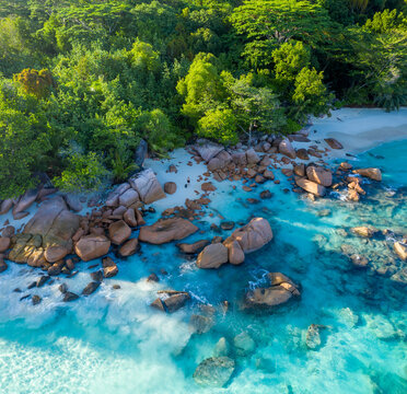 Aerial view of rocks on the beach along the coast at Anse Lazio beach, Seychelles.