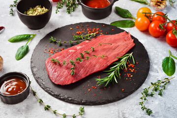 Fresh and raw fillet meat. Whole piece of beef tenderloin steaks set with spices and herbs. Meat....