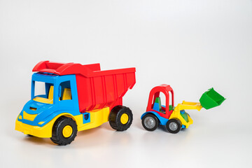 Multi-colored plastic children's toy cars on a white background.