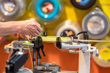 manual stringing of a badminton racket in service