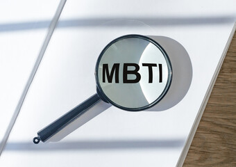 MBTI acronym, 16 personality types test concept. Magnifying lens.