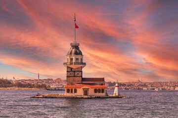 Maiden's Tower, "Kiz Kulesi" at sunset, purple and orange cloudy sky. Üsküdar-Istanbul on the Marmara Sea (Bosphorus) with historical mosques in the background. 