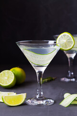 martini with lime.Cucumber water with lime. martini glass of lemonade with slices of lime and...