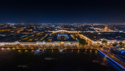 The picturesque night landscape of Winter Palace and Palace square with night illumination, night illumination of buildings and streets, many boats