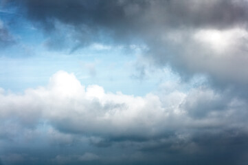 Daytime blue sky Background with white and black cumulus clouds . Dramatic sky overly. Soft focus.