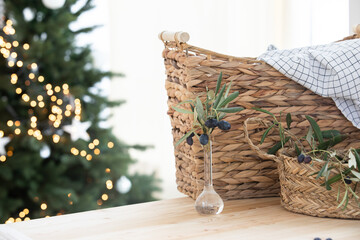 Scandinavian kitchen interior. Surface of a wooden table. Olives branch. Christmas interior.