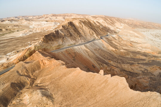 Aerial view of a winding road on a mountain side in the desert. Negev, Israel.
