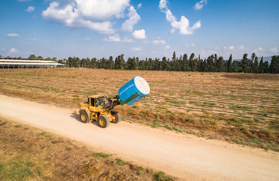 Aerial view of a tractor in a field picking cotton, Kibbutz Saar, Mate Asher, Israel.