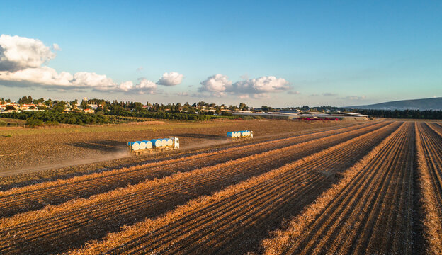 Aerial view of a tractor in a field picking cotton, Kibbutz Saar, Mate Asher, Israel.