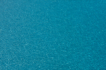Fototapeta na wymiar Tansparent clear calm water surface texture. Abstract nature background. Sea water pattern.