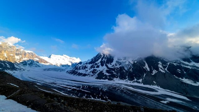Dramatic mountain landscape with low clouds. Glacier de Corbassiere and Grand Combin in Valais Alps (Pennine Alps), Switzerland.