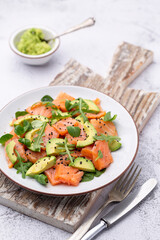 Fresh salmon salad with avocado,  for keto and low carb diet. Rusty background, top view, copy space.