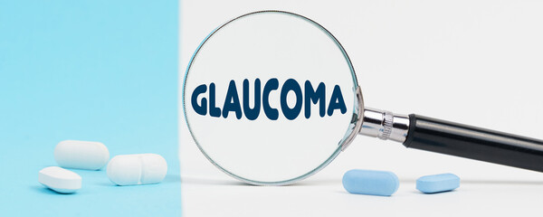 On a blue and white background, there are pills and a magnifying glass, inside of which it is...