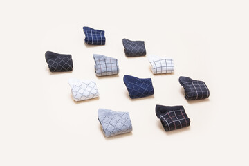 Nautical colored socks isolated on beige background; perspective view