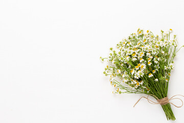 Chamomile flowers floral framee. Flat lay, top view.