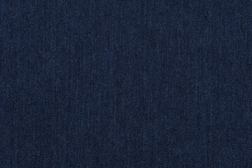 Blue jeans texture. Dark blue denim background.