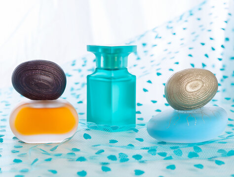 Three fragrances in frosted glass bottles