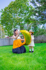 Naklejka premium A portrait of young mother with a small daughter in summer