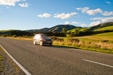 Car Speeding Along a Road in South Island New Zealand