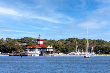 Hilton Head Island coastline viewr of lighthouse and sailboats on a beautiful and sunny, blue sky day.