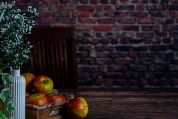 Apple on a wooden table as backdrop.background red brick wall.