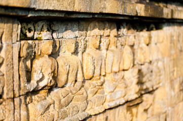 Close Up Photo of Detail of the Stone Bas Relief Carvings that Line the Walls of Borobudur Temple, Yogyakarta, Java, Indonesia, Asia, background with copy space