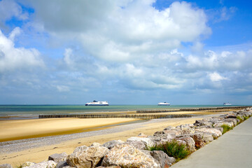 three car ferries meet on the english channel between Dover and Calais seen from the beach