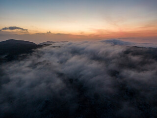 Aerial droen view of beautiful clouds with sunset  in mountain