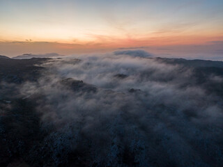 Fototapeta na wymiar Aerial droen view of beautiful clouds with sunset in mountain