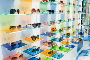 Different assortiment of UV protective eyewear frames on display panels in optical store. Select of...