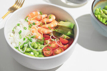 Poke bowl with red shrimps and vegetables in the bowl.Top view. Closeup.