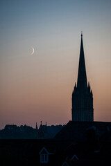 Fototapeta na wymiar Salisbury Cathedral with the moon at night, Wiltshire, England, United Kingdom, Europe