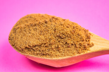 Coconut sugar in a wooden spoon