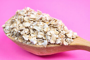 Healthy oatmeal in a wooden spoon