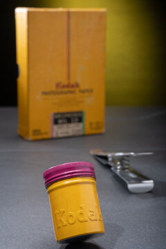Vintage tin 35mm film canister from the 1070s and retro photographic paper labelled with Kodak Eastman logo.