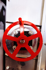 Red machine valve with wheel handle, close up