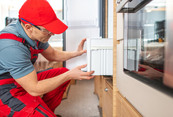RV Technician Worker Repairing Motorhome Refrigerator